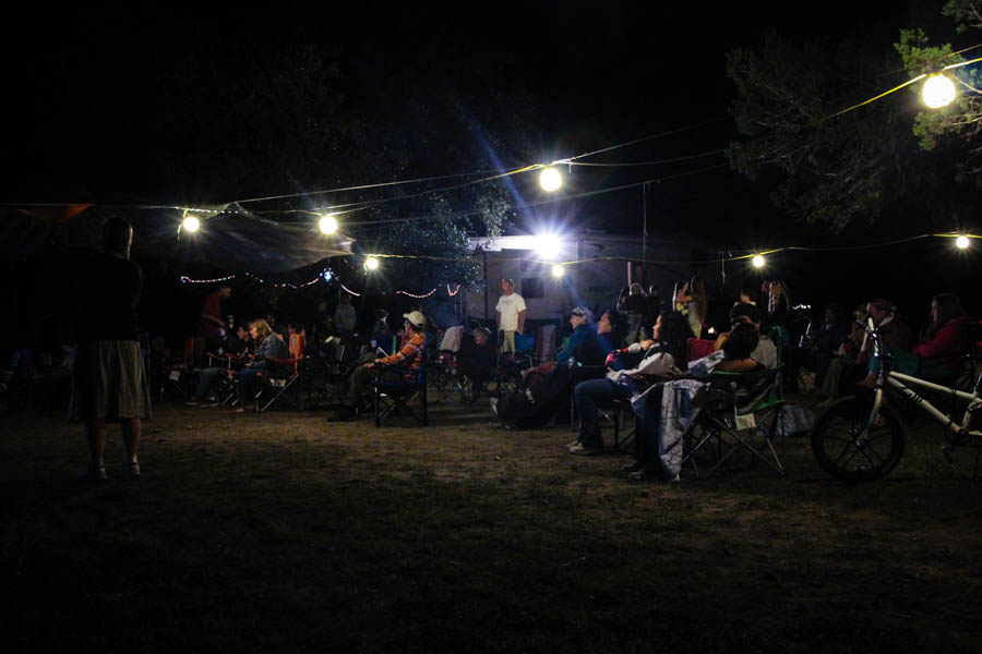 Evening gathering under string lights at the Sukkot campsite